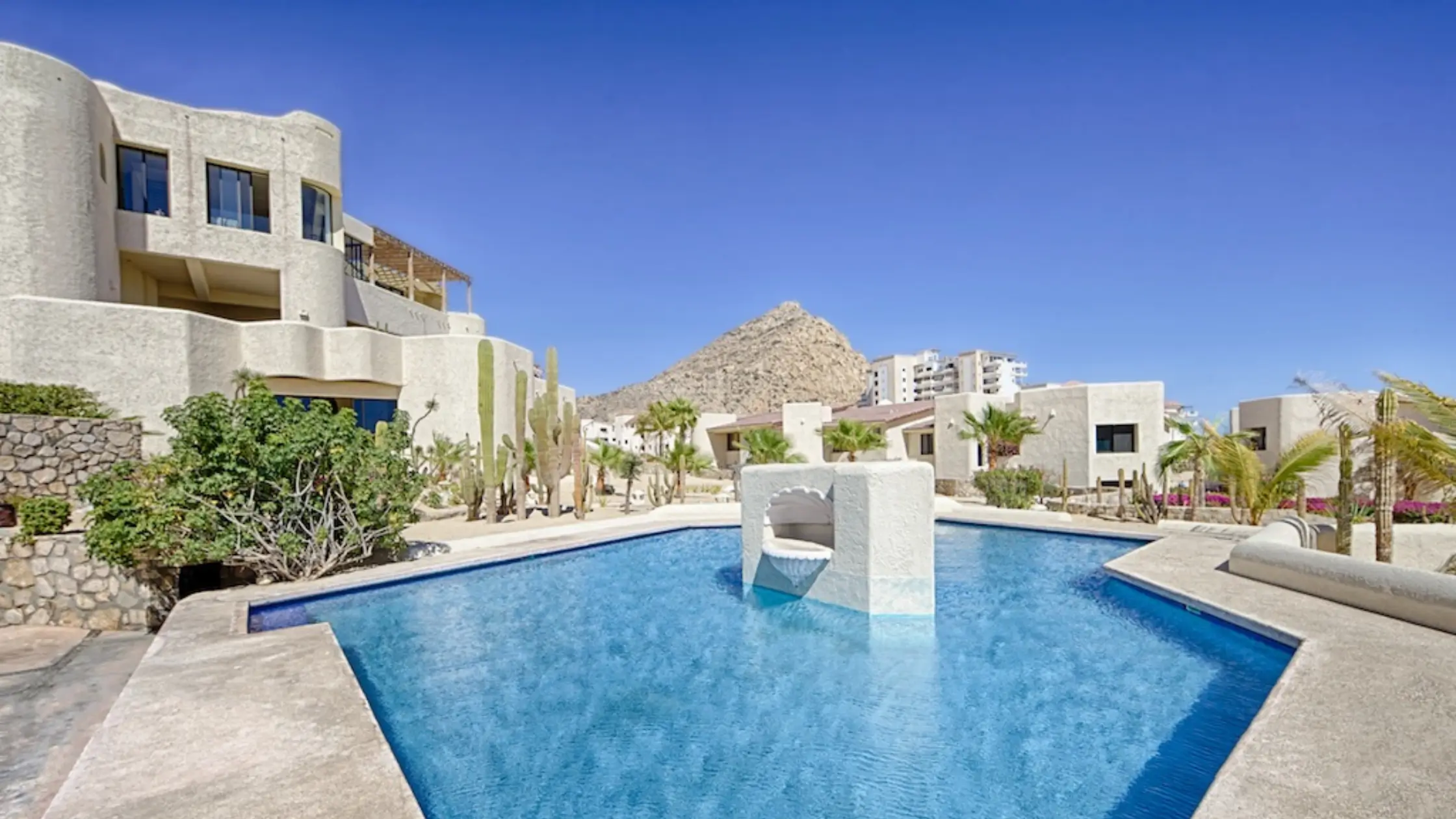 Beachfront Condos in Cabo San Lucas with infinity pool overlooking the Sea of Cortez at sunset